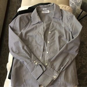 Not boxy. Flattering shape, easy to tuck in.Sleeves meant to be folded (cuffed)